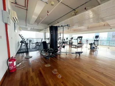 a gym with several treadmills and machines in a room at Infini Suites@ D'Majestic Place Kuala Lumpur in Kuala Lumpur