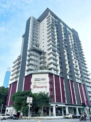 a large building with a sign in front of it at Infini Suites@ D'Majestic Place Kuala Lumpur in Kuala Lumpur