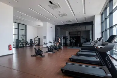 a gym with rows of treadmills and exercise bikes at Chambers near PWTC SunwayPutra KLCC InfinityPool in Kuala Lumpur