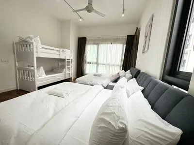 a large white bed in a room with a couch at TTs HOME3 Mews 4-8Pax Pavilion KLCC Kuala Lumpur in Kuala Lumpur