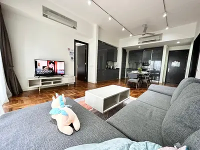 a living room with a couch with a stuffed animal on it at TTs HOME3 Mews 4-8Pax Pavilion KLCC Kuala Lumpur in Kuala Lumpur