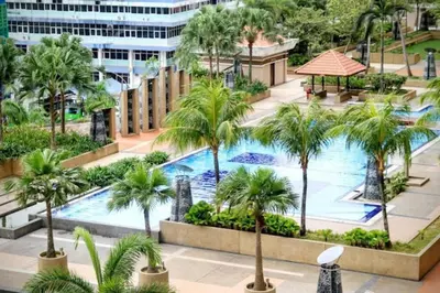 an overhead view of a swimming pool with palm trees at 3BR 8PAX KL City Centre KLCC View Ampang Boulevard Condo in Ampang