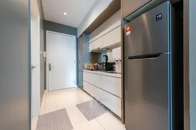 a kitchen with a stainless steel refrigerator and cabinets at Dorsett Residences Sri Hartamas (Kuala Lumpur) in Kuala Lumpur