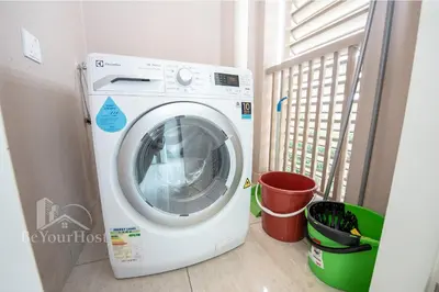 a washing machine in a room with a window at Dorsett Residences Sri Hartamas (Kuala Lumpur) in Kuala Lumpur