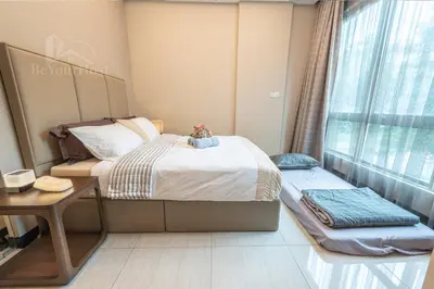 a bedroom with a bed and a desk and a window at Dorsett Residences Sri Hartamas (Kuala Lumpur) in Kuala Lumpur