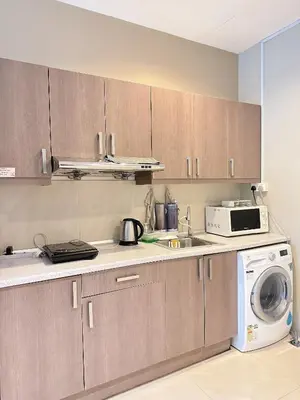 a kitchen with a microwave and a washing machine at Park View KLCC ,by DeLive Home in Kuala Lumpur