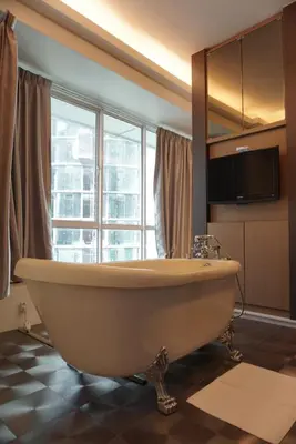 a bath tub in a bathroom with a large window at Park View KLCC ,by DeLive Home in Kuala Lumpur