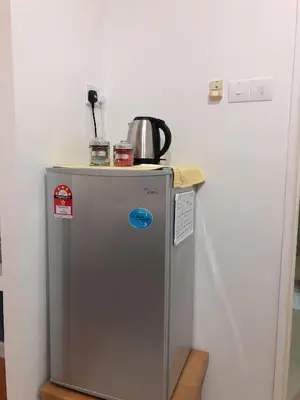 a small refrigerator with a pot on top of it at Park View KLCC ,by DeLive Home in Kuala Lumpur