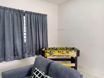 a living room with a blue couch and a window at The 29 Bungalow Setapak KL by Manhattan Group in Kuala Lumpur