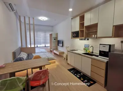 a kitchen and living room with a couch and a table at I-Concept Homestay in Kuala Lumpur