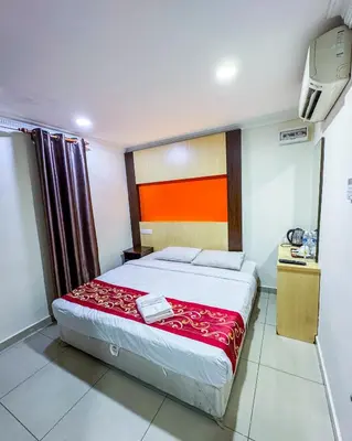 a bedroom with a bed with a red blanket at THE STARION HOTEL BUKIT BINTANG in Kuala Lumpur