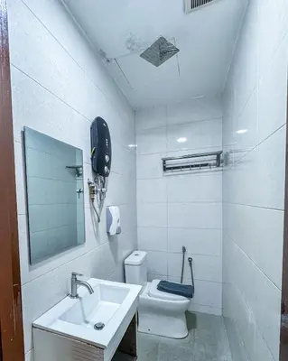 a white bathroom with a sink and a toilet at THE STARION HOTEL BUKIT BINTANG in Kuala Lumpur