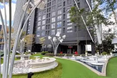a large building with a green lawn in front of it at Zen-Inspired Duplex Luxury 6Pax, Arte Mont Kiara by Verano in Kuala Lumpur