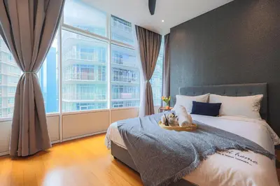 a bedroom with a cat sitting on a bed at Sky Suite KLCC, Calm Sojourn in Kuala Lumpur
