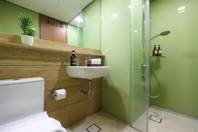 a bathroom with a toilet and a sink and a shower at Sky Suite KLCC, Calm Sojourn in Kuala Lumpur