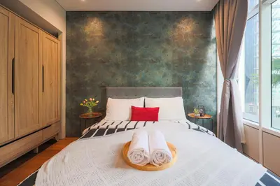 a bedroom with a bed with towels on it at Sky Suite KLCC, Calm Sojourn in Kuala Lumpur