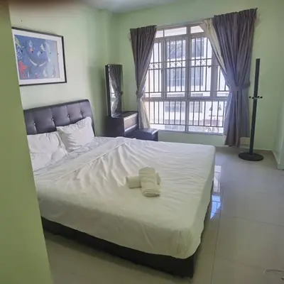 a bedroom with a bed with two towels on it at Warisan cityview jalan cheras 56000KL in Kuala Lumpur