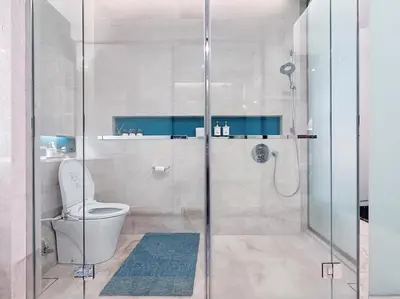 a bathroom with a toilet and a glass shower at Luxury Suites at Tropicana Residences KLCC by VV in Kuala Lumpur