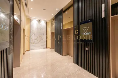 a lobby of a luxury store with a sign on the wall at Axon Premier Suites Kuala Lumpur in Kuala Lumpur