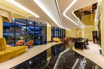 a lobby with chairs and tables in a building at Axon Premier Suites Kuala Lumpur in Kuala Lumpur