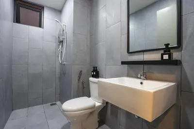 a bathroom with a sink and a toilet and a mirror at Lovely 3-bedroom w pool 7 pax - Jalan Cheras in Kuala Lumpur