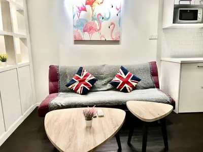 a living room with a couch and two tables at Summer suites near klcc in Kuala Lumpur