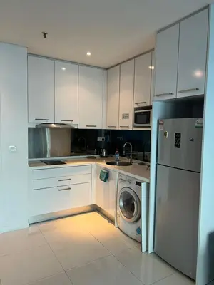 a kitchen with a washing machine and a washer at Summer suites near klcc in Kuala Lumpur