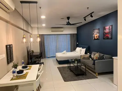a living room with a bed and a couch at Summer suites near klcc in Kuala Lumpur