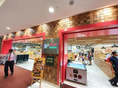 a store with people walking inside of a shopping mall at Arcoris Mont Kiara 163 in Kuala Lumpur
