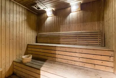 a wooden sauna with a bucket in it at Arcoris Mont Kiara 163 in Kuala Lumpur