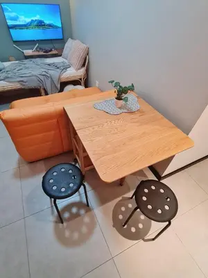 a living room with a wooden table and two chairs at Cozy Modern Tiny Home 2R1B 10 mins to KLCC in Kuala Lumpur