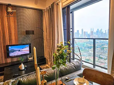a living room with a couch and a large window at 1 min to KL Tallest Residence Heart of Klang Valley in Kuala Lumpur