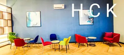 a room with chairs and tables and a wall with the word lick at Luxury Balcony at Trion KL by HCK in Kuala Lumpur
