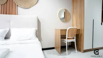a bedroom with a bed and a desk with a mirror at NeuSuite Cozy Studio by GUESTONIC in Kuala Lumpur