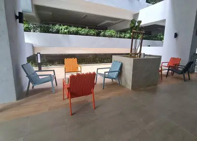 a group of chairs and tables in a building at Homeaway 2R1B 10 mins to KLCC in Kuala Lumpur