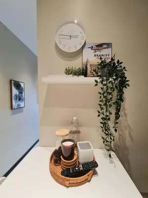 a clock on a wall above a table with a tray of food at Homeaway 2R1B 10 mins to KLCC in Kuala Lumpur