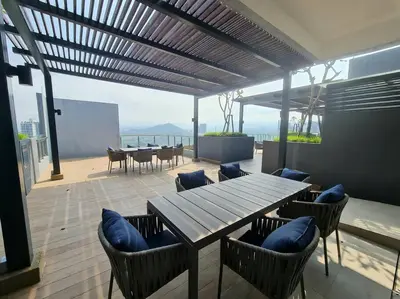 a patio with a wooden table and chairs and the ocean at Homeaway 2R1B 10 mins to KLCC in Kuala Lumpur