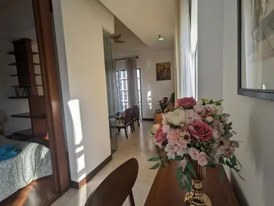 a vase of flowers on a table in a hallway at Damansara Studio in Kuala Lumpur