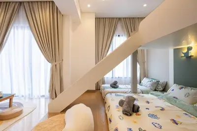 a childs room with a bunk bed and a staircase at Cute Dinosaur Kids Theme@Lucentia LalaPort BBCC in Kuala Lumpur