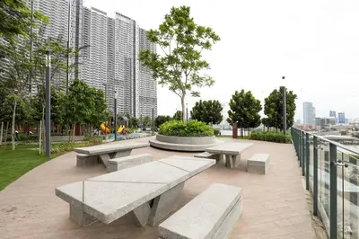 a park with benches and a fountain and buildings at M Vertica KL Residence in Kuala Lumpur