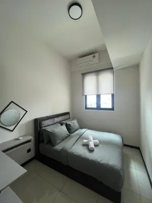 a bedroom with a bed with a teddy bear on it at Opus Residences 2 Bedroom Apartment in Kuala Lumpur