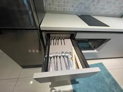 a kitchen with a drawer with knives in it at Opus Residences 2 Bedroom Apartment in Kuala Lumpur