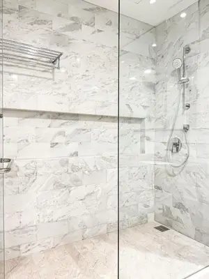 a bathroom with a shower with a stone wall at KL Tower KLCC Pavilion by Kimiro in Kuala Lumpur
