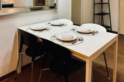a dining room table with plates and dishes on it at Comfy-Concept Apartment @ B.Bintang (3min walk LRT, Lalaport, TimeSquare) in Kuala Lumpur