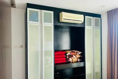 a white cabinet with a air conditioner in a room at Comfy-Concept Apartment @ B.Bintang (3min walk LRT, Lalaport, TimeSquare) in Kuala Lumpur