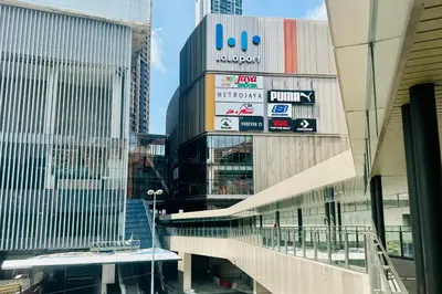 a tall building with signs on it in a city at Comfy-Concept Apartment @ B.Bintang (3min walk LRT, Lalaport, TimeSquare) in Kuala Lumpur