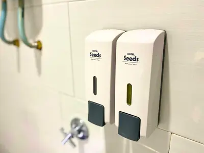 two rolls of toilet paper on the wall of a bathroom at Seeds Hotel Chow Kit in Kuala Lumpur