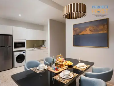 a kitchen and dining room with a table and chairs at Pavilion Ceylon Hill Suites, Bukit Bintang by Perfect Host in Kuala Lumpur