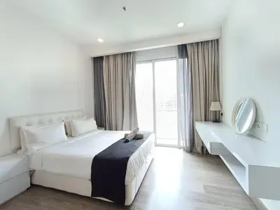 a white bedroom with a large bed and a mirror at RM218 Bukit Bintang Balcony Studio Infinity Pool in Kuala Lumpur