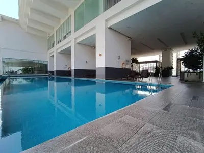 a large swimming pool in a building with blue water at RM218 Bukit Bintang Balcony Studio Infinity Pool in Kuala Lumpur